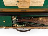 an old gun in a wooden case with a label on it