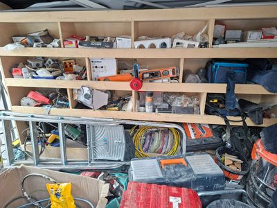 a lot of clutter and tools in the back of a truck