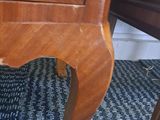 a small wooden table with a clock on top of it