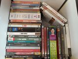many dvds stacked on top of each other on a shelf
