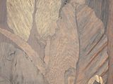 a picture of a wood carving of a leaf on a wall