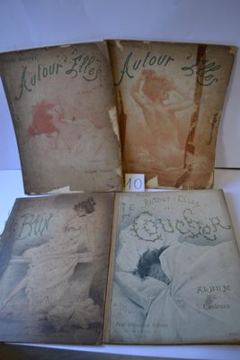 three old books are sitting on a table with a white background