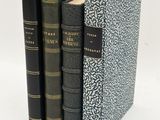 three books sitting on top of each other on a white surface