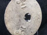 an old coin with a hole in the middle of it