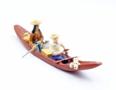 two figurines of a man and a woman in a boat