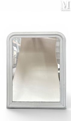 a small square mirror on a white surface