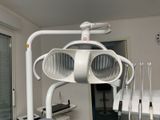 an image of a medical room with a chair and lights