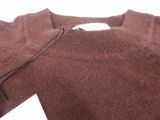 a brown sweater with a tag attached to it