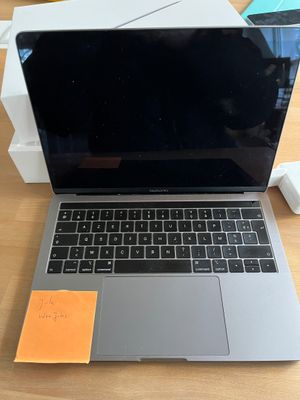 an apple macbook pro laptop computer sitting on top of a wooden table