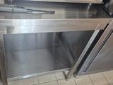 stainless steel ovens in a commercial kitchen with tiled flooring