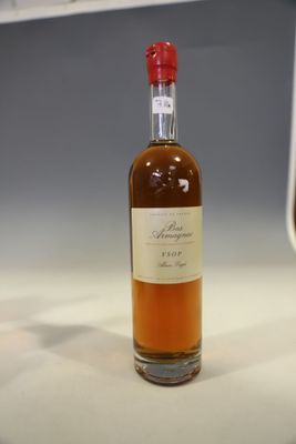 a bottle of whiskey sitting on a counter next to a glass