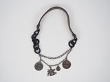 a close up of a necklace on a white surface