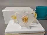 a small white box with a perfume bottle and a box with a perfume