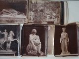 many pictures of statues on display in a glass case