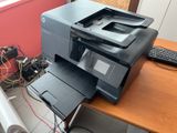 a printer sitting on top of a desk next to a keyboard