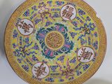 two plates with asian designs on them on a table