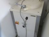 a small white sink in a small bathroom with a faucet attached to it