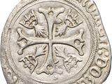 a close up of a coin with a cross on it