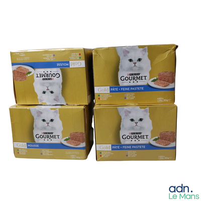 four boxes of gourmet cat food stacked on top of each other