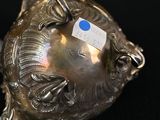 a silver object with a tag on it on a black surface