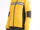 the woman is wearing a yellow jacket and black pants