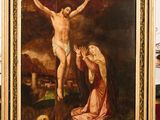 a painting of jesus on the cross with a woman kneeling next to him
