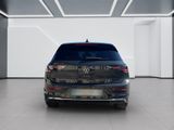 the rear end of a black volkswagen vehicle in a white room