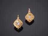 a pair of gold and diamond earrings