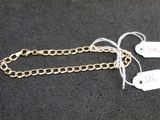 a close up of two tags attached to a chain on a table