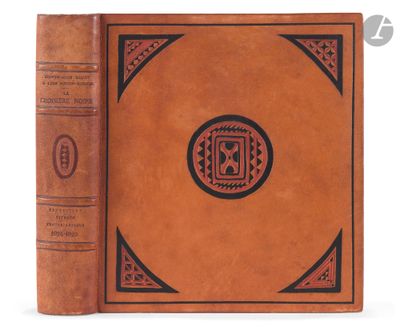 a brown book with a black and red design on it