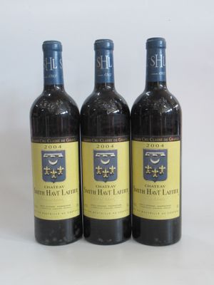 three bottles of wine sitting on top of a table next to each other