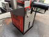a machine that is sitting on the ground in the garage