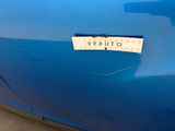 a close up of a blue car with a sticker on it