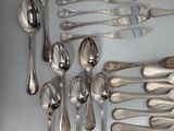 a lot of silver spoons and spoon spoons on the table