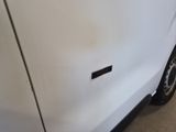 a white van that has a sticker on the side of it
