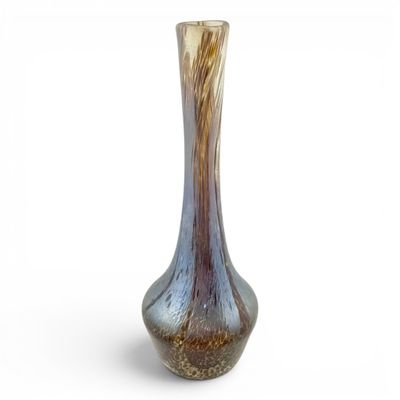 a glass vase that is sitting on a white surface