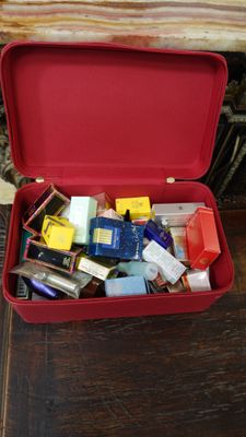 a red suitcase filled with assorted items on a table