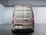 the rear end of a silver van parked in a garage
