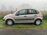 a small car that is parked on the side of the road