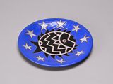 a picture of a blue plate with a black and white design on it