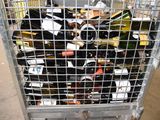 a metal cage filled with bottles of wine on the street
