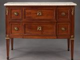 an antique chest of drawers with marble top