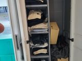 a closet full of clothes and boxes in a room