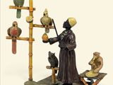 figurine représentant un moine avec un chat et des oiseaux, posée sur un socle