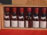 bottles of red wine in a wooden box on a table