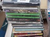 many cds stacked on top of each other in a room