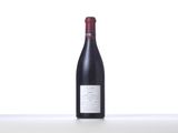 a bottle of red wine sitting on a table