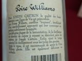 a bottle of wine sitting on a table next to a cell phone