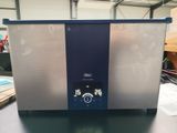an image of a silver and blue chest freezer sitting on a table