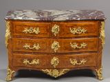 an antique chest of drawers with a marble top